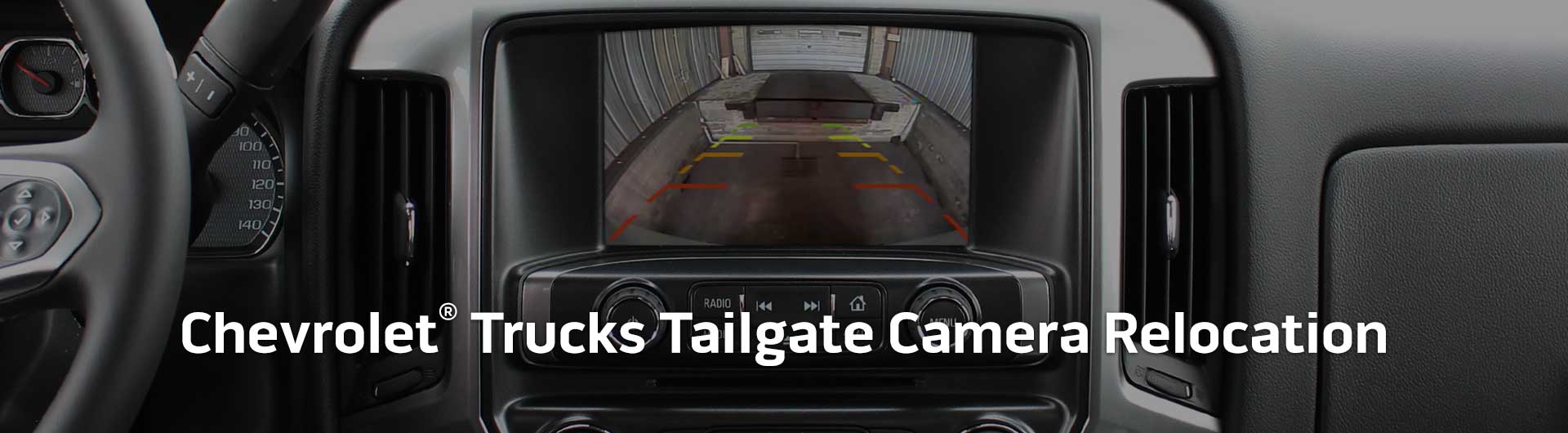 An image showing the in-dash monitor of a Chevrolet truck. The in-dash monitor shows that the truck is in reverse and is displaying both the backup camera and video from the cameras on the front and side of the truck. The image has text that reads Chevrolet Trucks Tailgate Camera Relocation.
