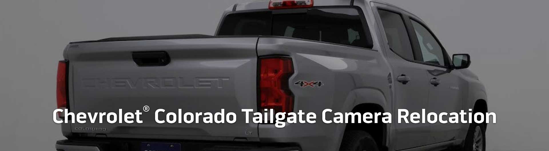 An image showing the tailgate of a Chevrolet Colorado truck. Text overlaid onto the image reads Chevrolet Colorado Tailgate Camera Relocation