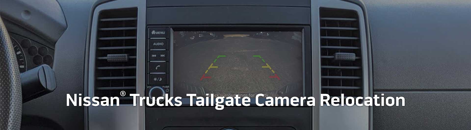 An image showing the in-dash monitor of a Nissan truck. The in-dash monitor shows that the truck is in reverse and is displaying both the backup camera and video from the cameras on the front and side of the truck. The image has text that reads Nissan Trucks Tailgate Camera Relocation.