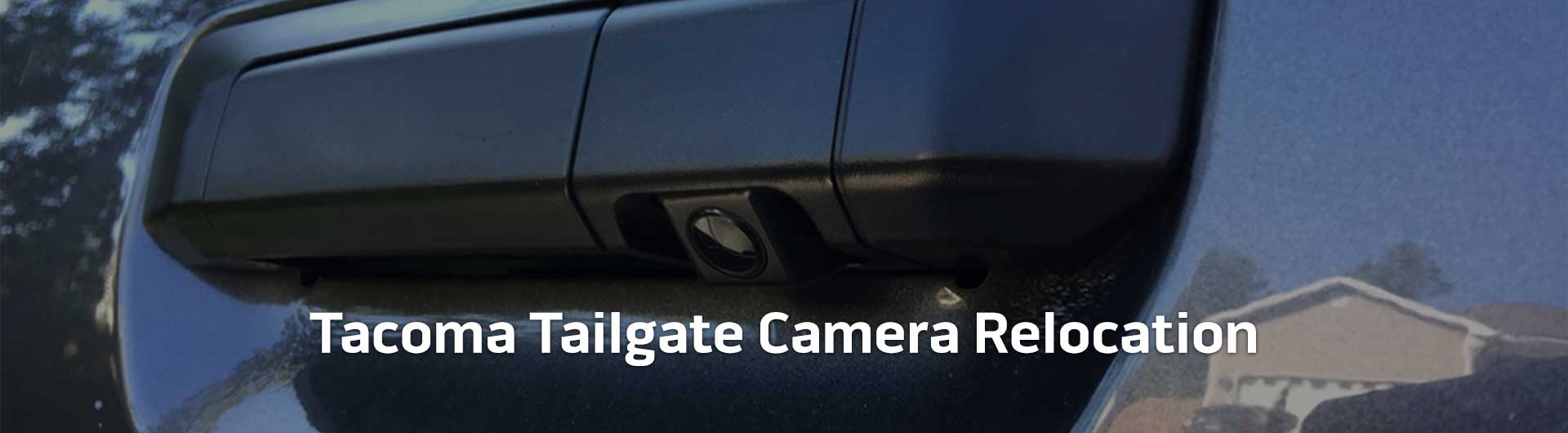 An image showing the tailgate handle of a Toyota Tacoma. The tailgate handle has a backup camera integrated into it. The image has text that reads Toyota Tacoma Tailgate Camera Relocation.