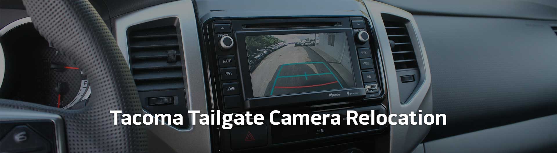 An image showing the in-dash monitor of a Toyota Tacoma. The in-dash monitor shows that the truck is in reverse and is displaying the backup camera. The image has text that reads Toyota Tacoma Tailgate Camera Relocation.