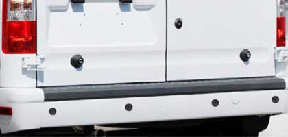 An image showing the rear bumper of a van. Four ultrasonic parking sensors are flush-mounted in the bumper.