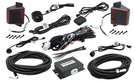 An image showing the components of the 250-1930 blind spot detection and rear cross-traffic alert system from Rostra. The image includes the sensors, control module, GPS antenna, LED displays, and other components for a complete installation.