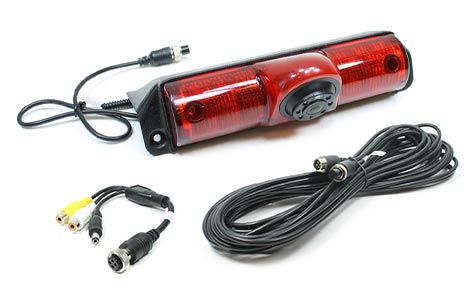 This image depicts a high-mount backup camera for a 2012-2017 Nissan NV van. The image includes the camera, the extension harness, and RCA adapter against a plain white background.
