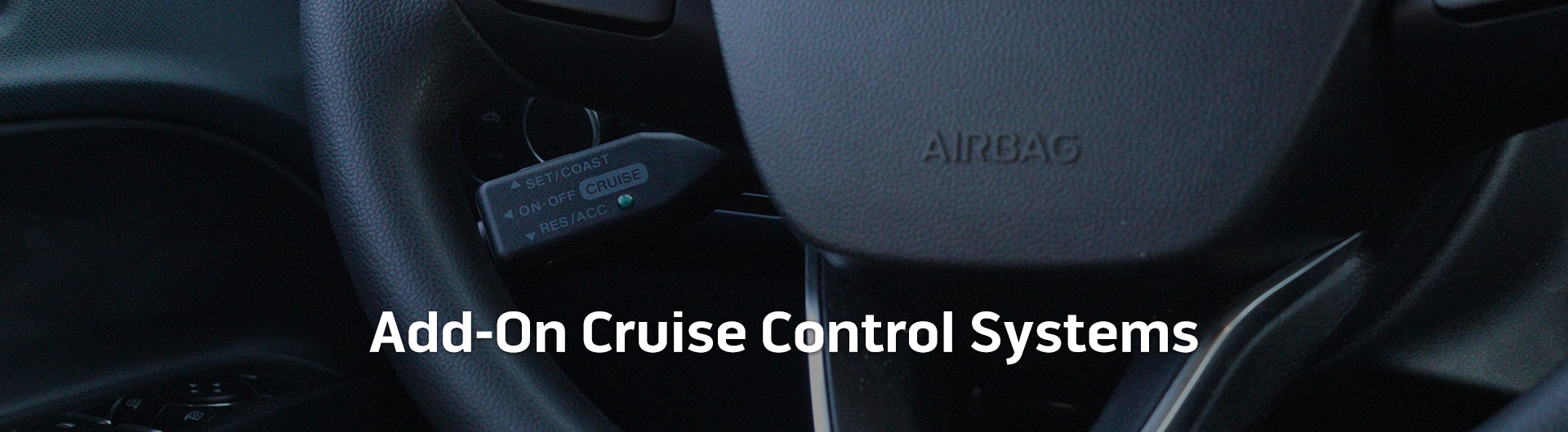 An image showing a cruise control switch installed on a vehicle. The image has text that reads Add-On Cruise Control Systems