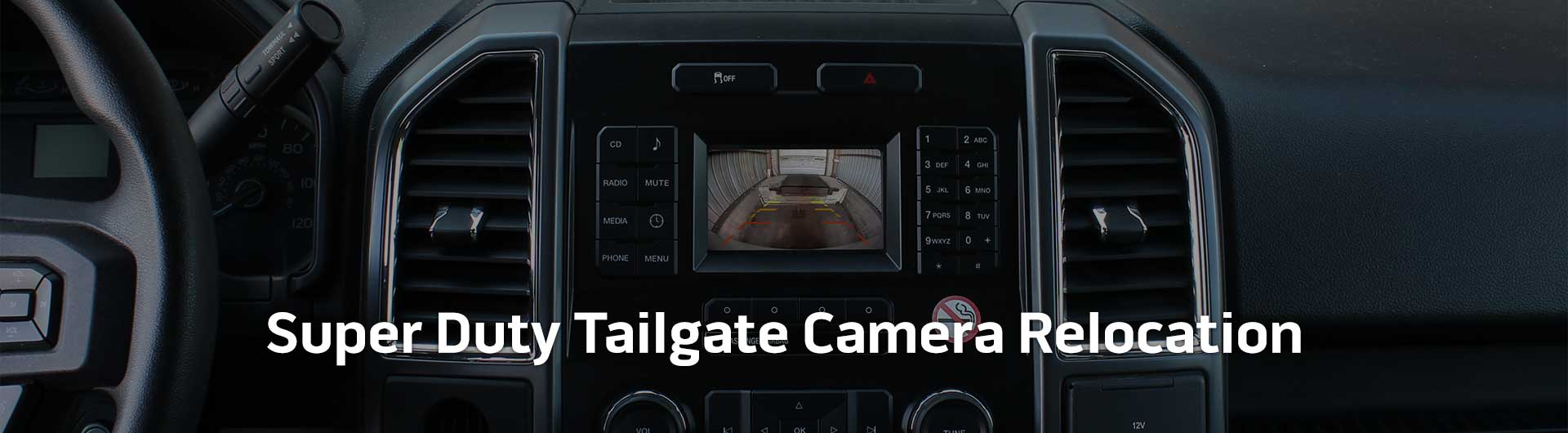 An image showing the in-dash monitor of a Ford truck. On the screen is an image from the backup camera.