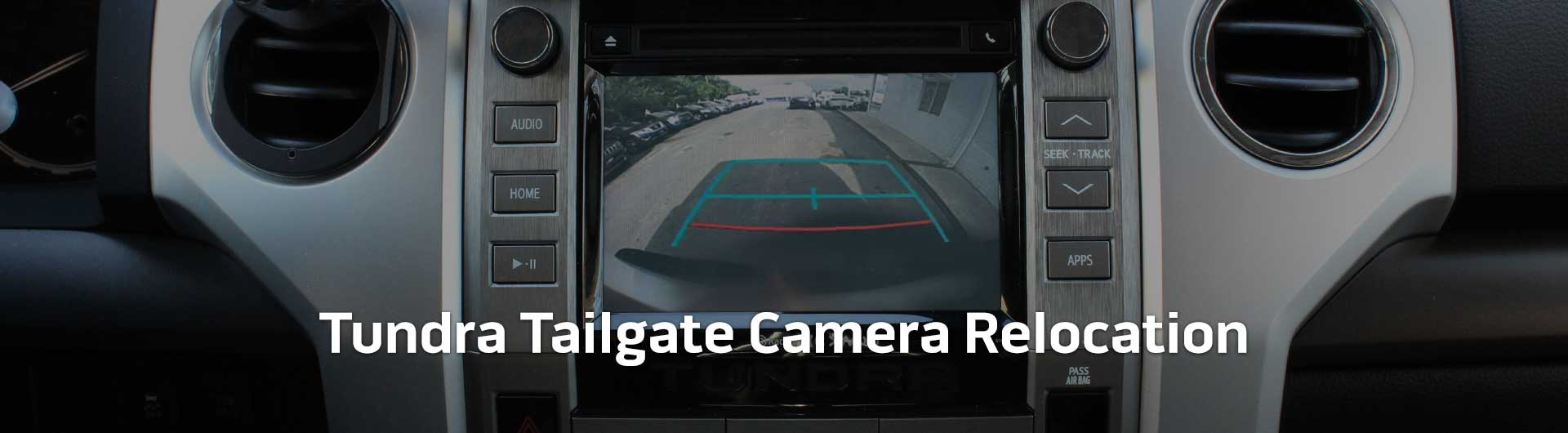 An image showing the in-dash monitor of a Toyota Tundra. The in-dash monitor shows that the truck is in reverse and is displaying the backup camera. The image has text that reads Toyota Tundra Tailgate Camera Relocation.