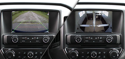 An image showing two vehicle dashboards side-by-side with one showing video from a backup camera and one showing video from an auxiliary camera.
