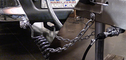 An image showing the coil cable and harness connectors on the back of a truck an front of a trailer used to send video to an in-vehicle monitor when the trailer is hitched to the truck.