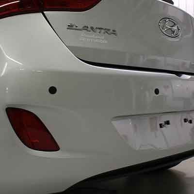 The rear bumper of a car with parking sensors installed.