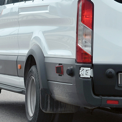 The side of a work van with blind spot detection sensors visible