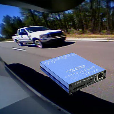 An image captured from a digital video recording system on a vehicle showing a large truck in the lane beside a car.