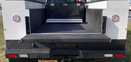An image showing the rear bumper of a vehicle. Four ultrasonic parking sensors are flush-mounted in the bumper.