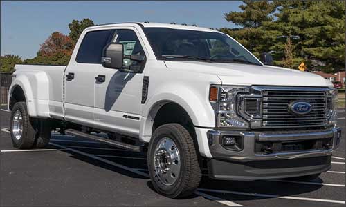 An image of a white Ford Super Duty truck with a standard truck bed box