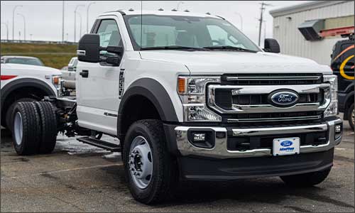 An image of a white Ford Super Duty truck with a Cab & Chassis design with no truck bed installed