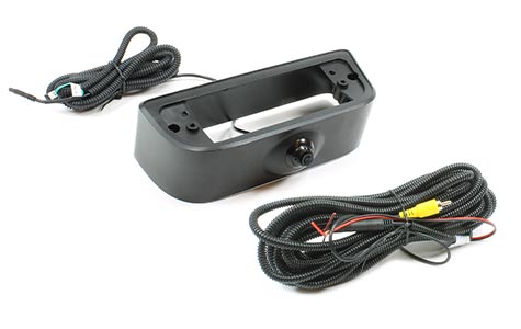 This image depicts a high-mount backup camera for a 2014-2017 Nissan NV200/Chevrolet City Express van. The image includes the camera, the extension harness, and RCA adapter against a plain white background.