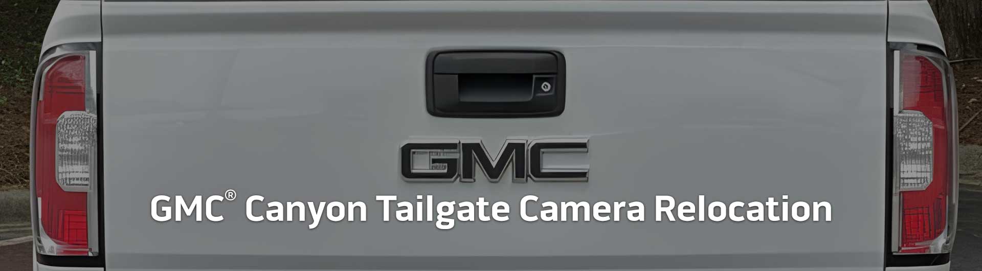 An image showing the tailgate handle of a GMC Canyon with a built-in backup camera.
