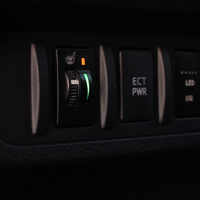 Dashboard of a Toyota vehicle with the 250-1870-TOY seat heater control switch installed and illuminated