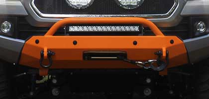 An image showing the front bumper of a vehicle. Four ultrasonic parking sensors are flush-mounted in the bumper.